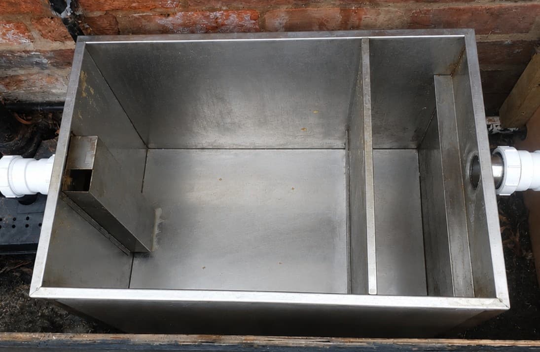 Grease trap after cleaning with the internals cleared and restored